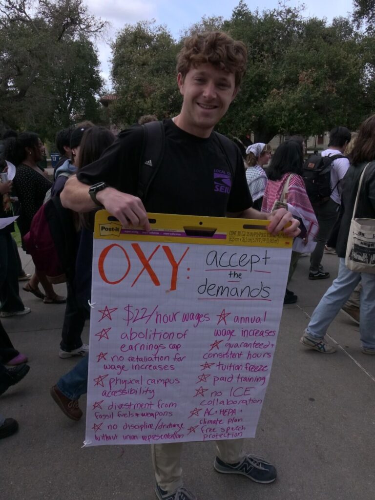 A protester with a sign listing union demands, on the Academic Quad at Occidental College in Los Angeles. March 6, 2024. James Miller/The Occidental